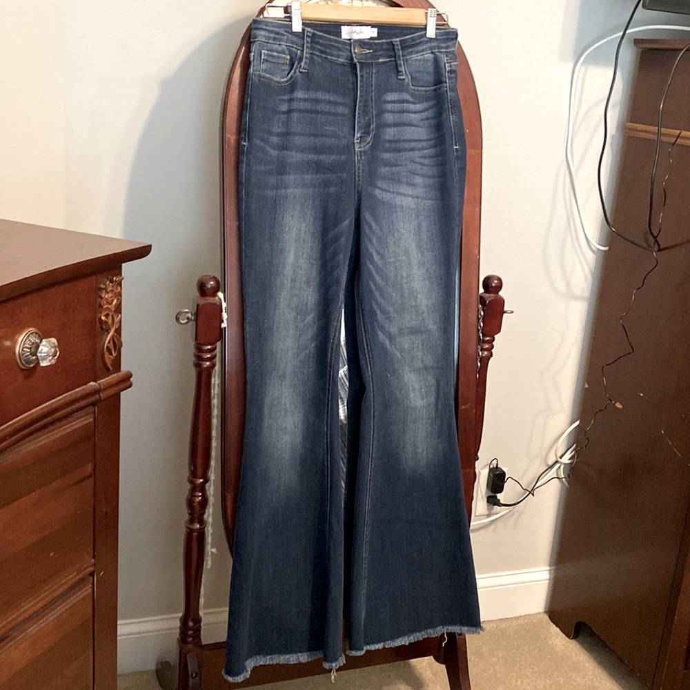 Jelly Jeans flare legs with frayed bottoms on legs.